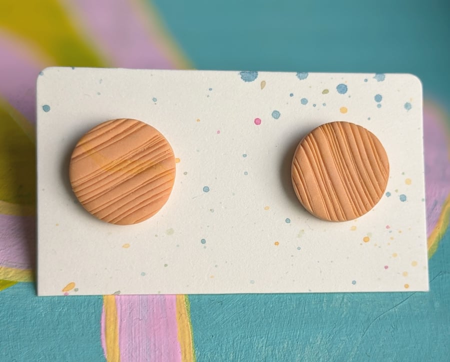 Orange textured thin line large stud earrings. 