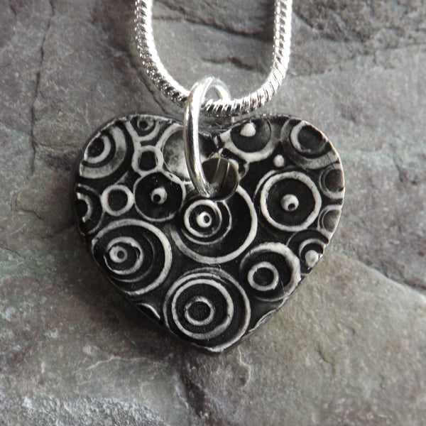 Heart shaped ceramic pendant in black white and grey 