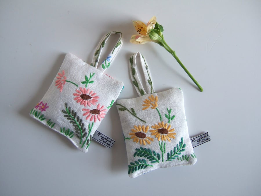 A pair of lavender bags with vintage floral embroidery