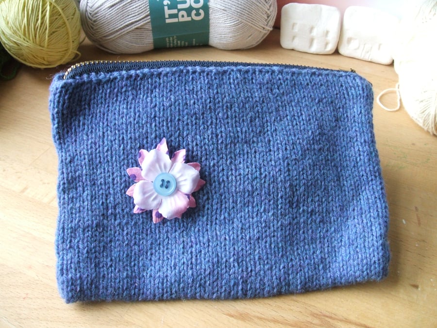 hand knitted blue zipped purse or bag with button flower detail