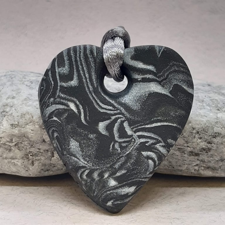 Black and silver heart shaped pendant