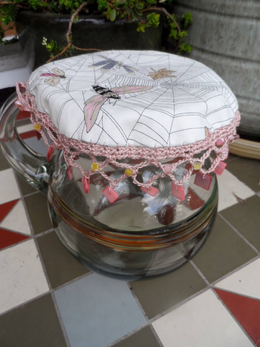 Beaded jug cover, reversible in co-ordinating moth print. Crochet edging, beaded