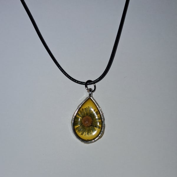 Handmade yellow daisy pendant on black waxed cord