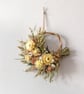 Small handmade dried flower pale yellow and apricot wreath hanging