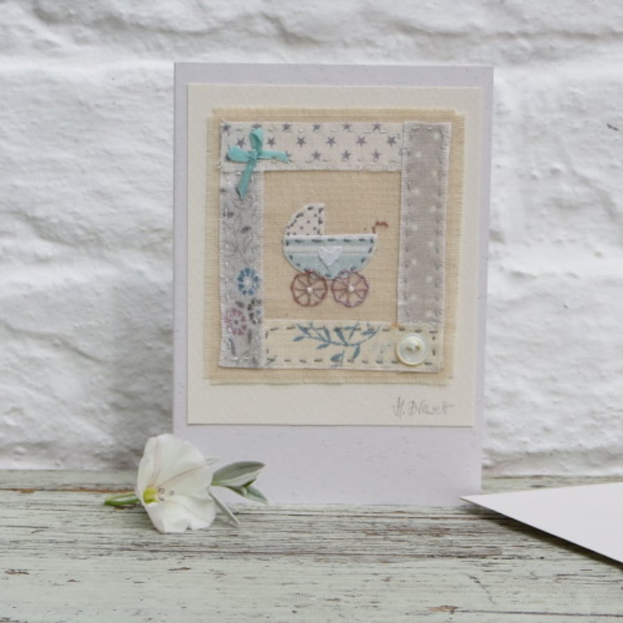 Little pram embroidered card to welcome a new baby, silk bow and mop button