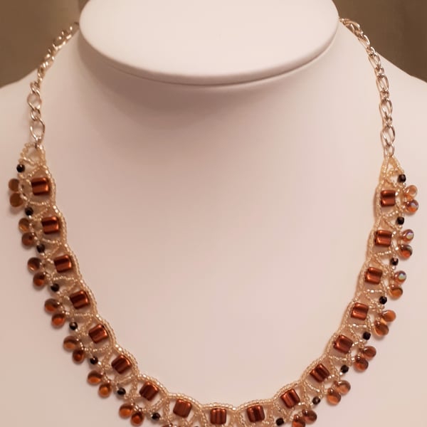 Collar  style necklace in shades of bronze, brown and gold