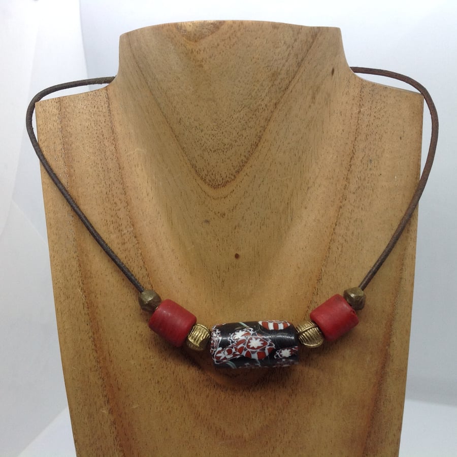 A cord necklace with giant black and red trade bead for men or women