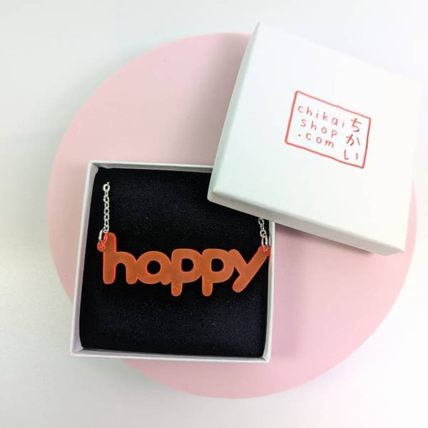 happy necklace on neon pink translucent acrylic with silver plated chain