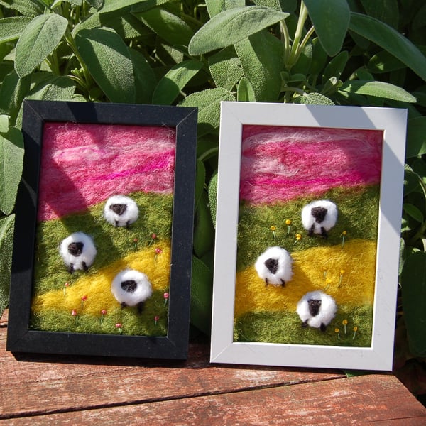 Colourful sheep wool painting.  Needlefelt picture of three sheep and flowers