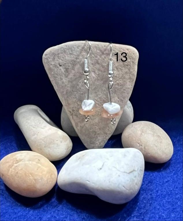 Beautiful dangling earrings with orange and white stones.