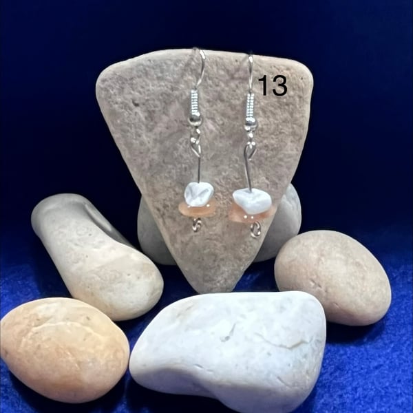 Beautiful dangling earrings with orange and white stones.