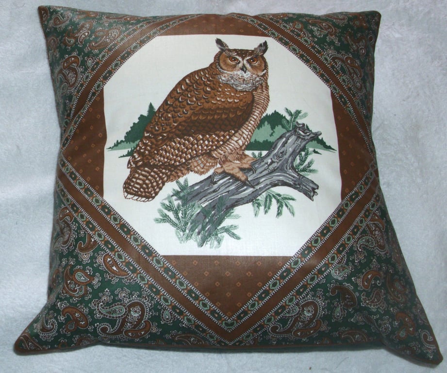 Eagle Owl  looking watchful, perched on a branch cushion