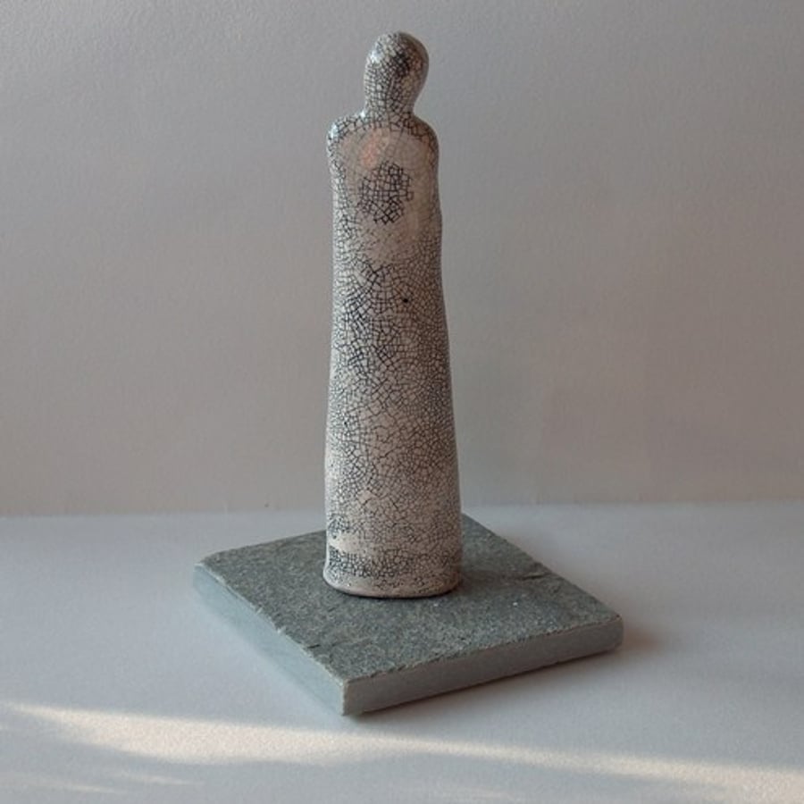 Ceramic Figure on Slate Tile.