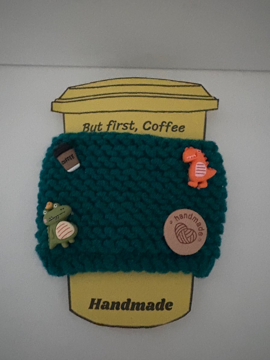 Dinosaur knitted cup cosy. 