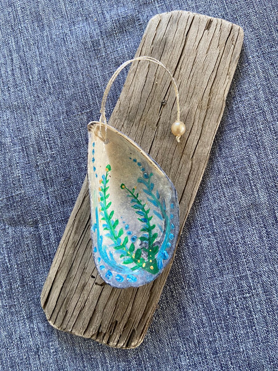 Hand painted mussel shell from an Argyll beach. With a beaded hanger.