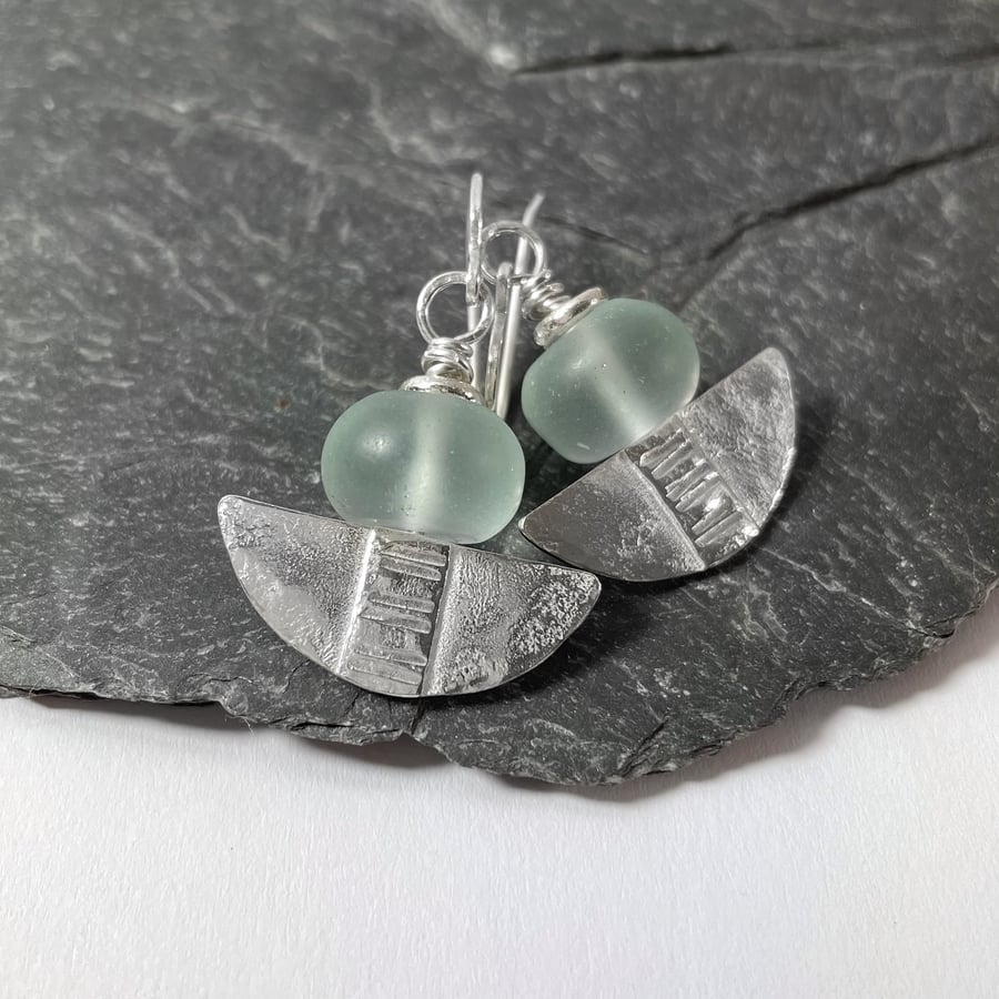 Silver and aqua glass tribal blade earrings.