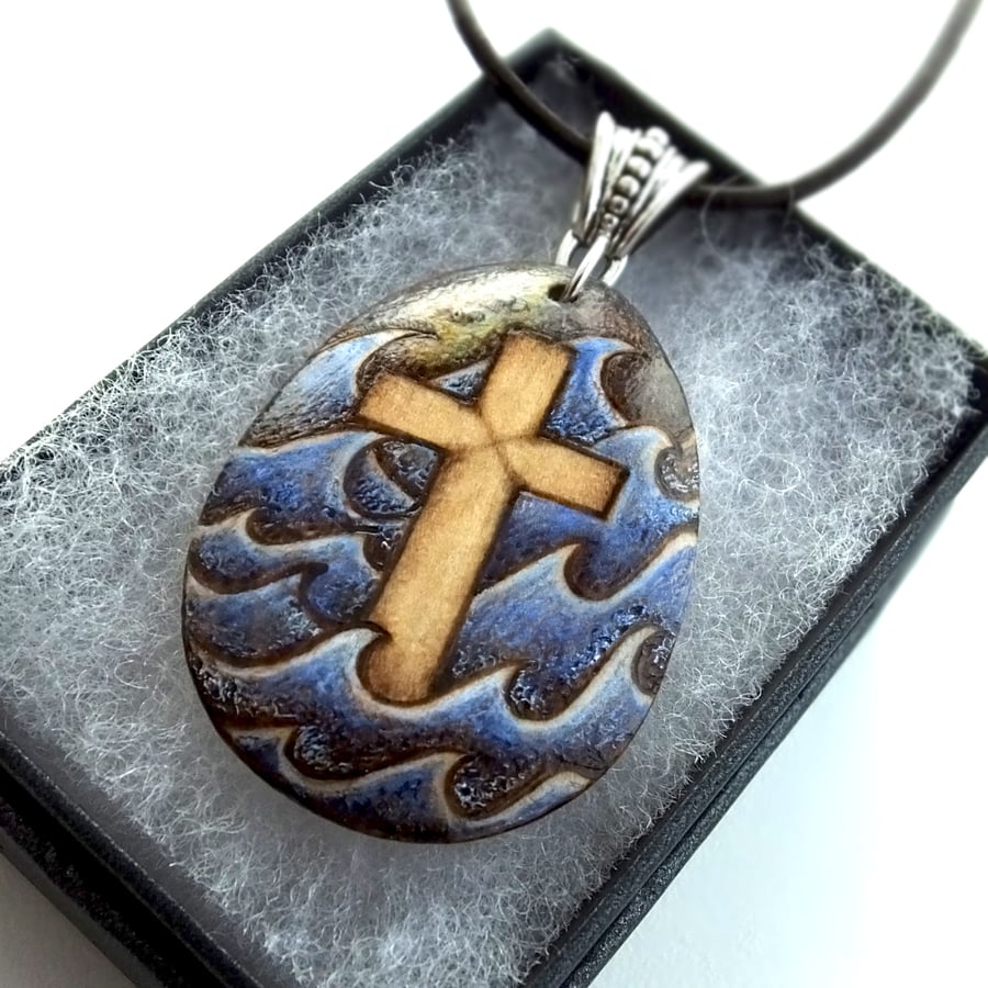 Pyrography Christian cross in a turbulent sea. Wooden teardrop necklace.