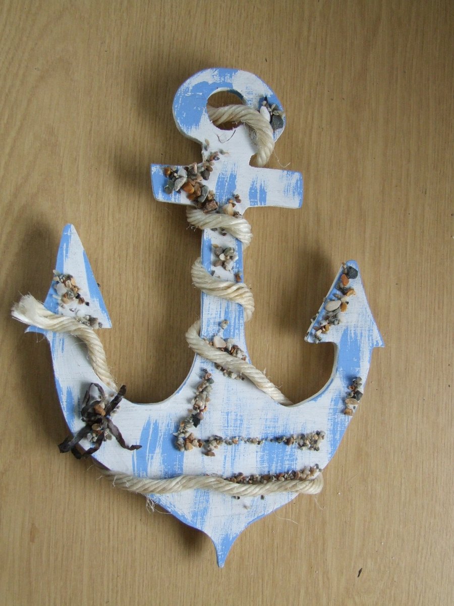 Decorative ships anchor wallhanging in blue with pebbles and sea shells.