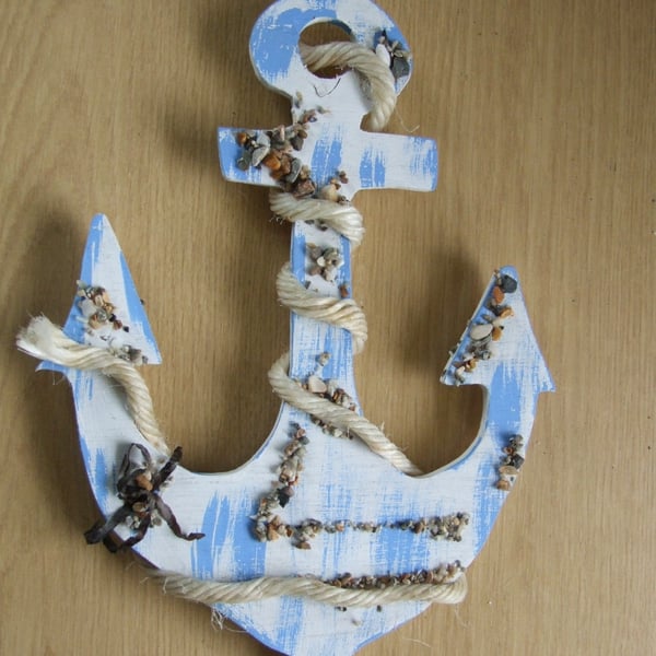 Decorative ships anchor wallhanging in blue with pebbles and sea shells.