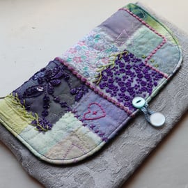 Handmade, embroidered clutch bag in silver, purple and mint green