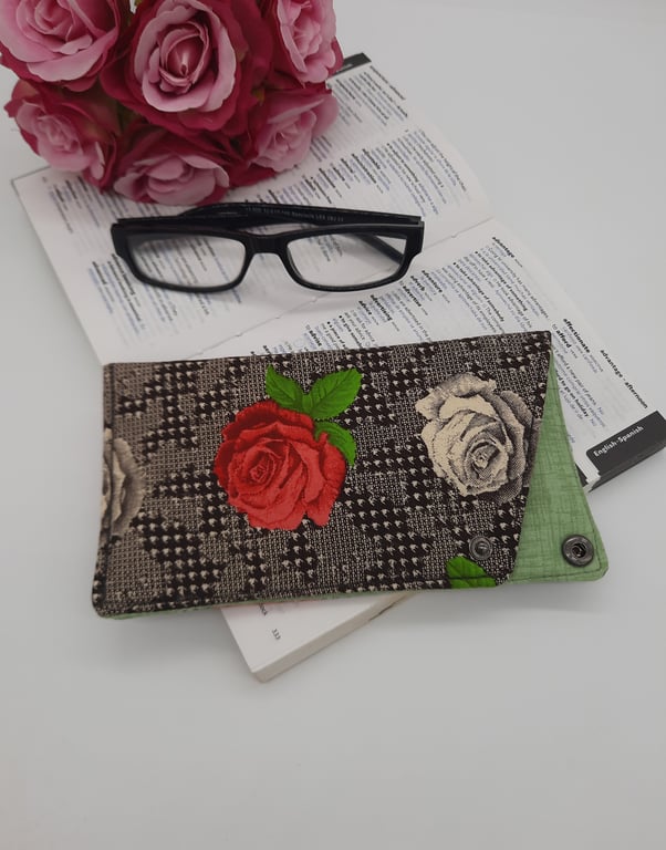Cream and raspberry pink rose glasses case with dark grey popper fastening.