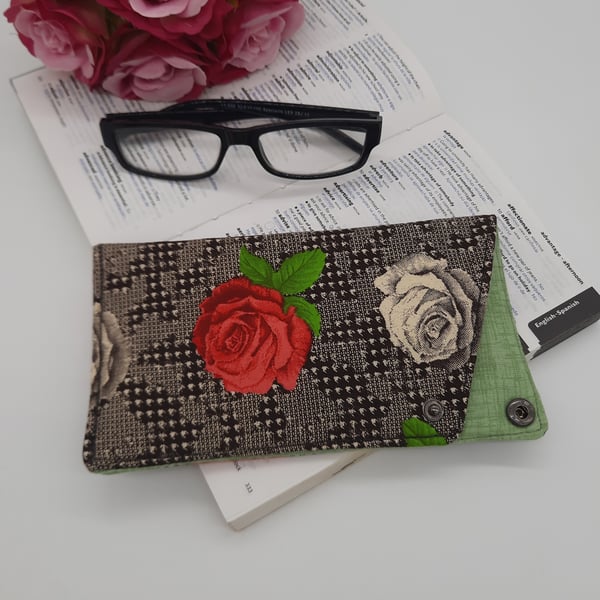 Cream and raspberry pink rose glasses case with dark grey popper fastening.