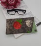 Cream and raspberry pink rose glasses case with dark grey popper fastening. - Image 1
