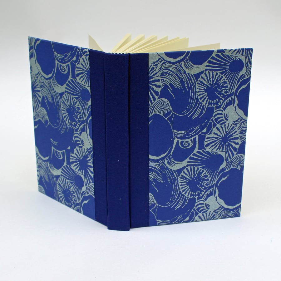 Notebook with lined paper and handbound with handprinted paper with shells
