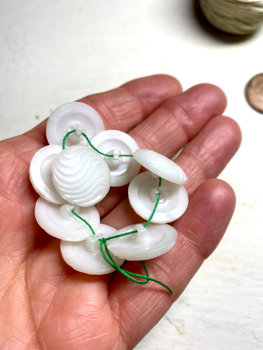 Set of 9 white domed buttons with shank