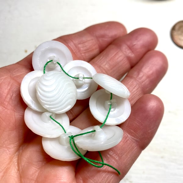Set of 9 white domed buttons with shank
