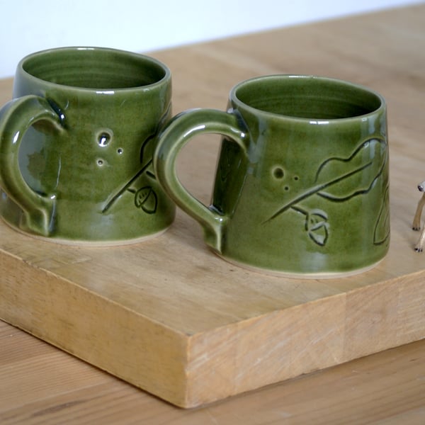 Sale - One hand thrown pottery mug with leafy acorn pattern glazed in green
