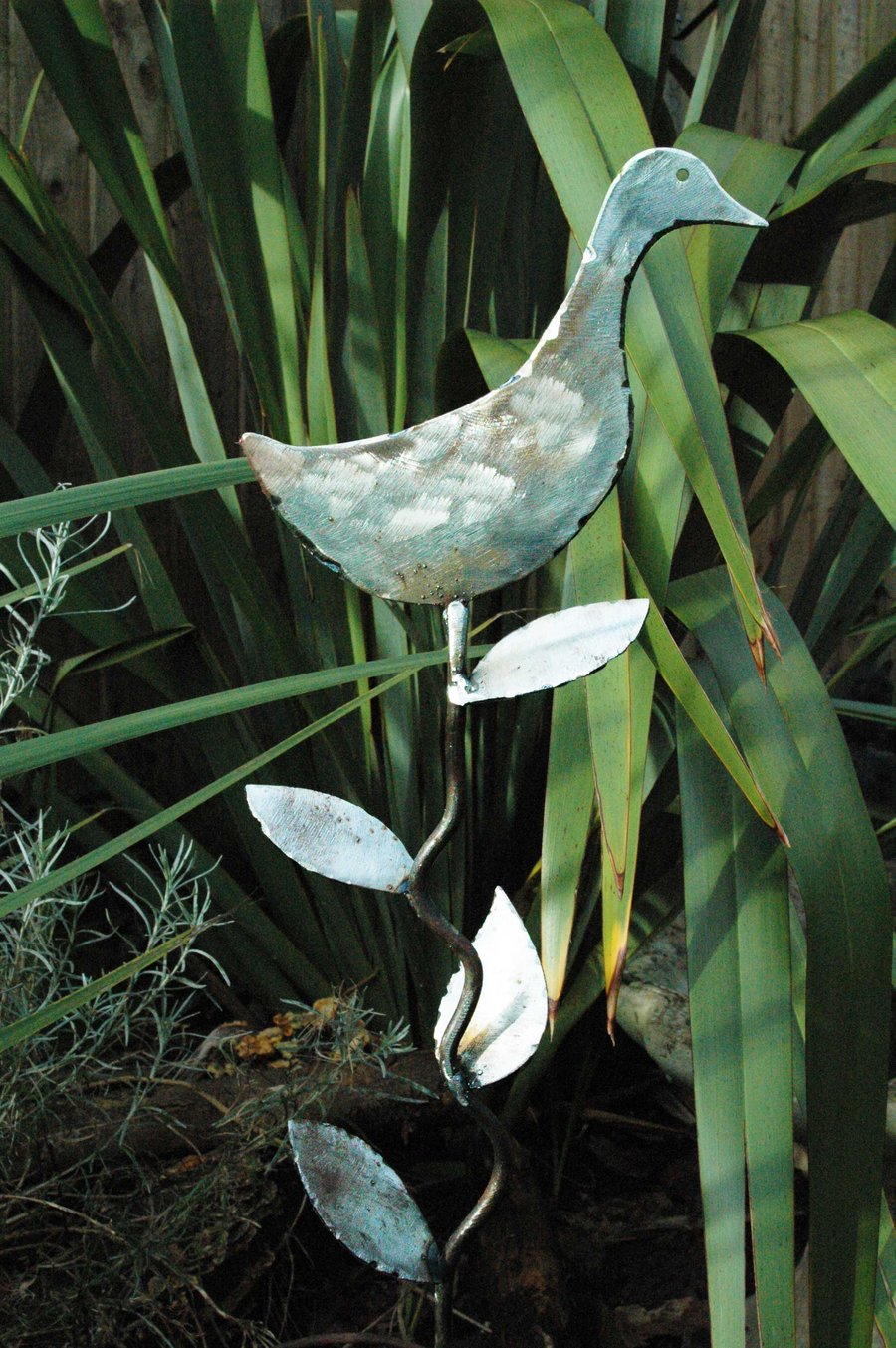 Sculptured metal duck with leaves plant support