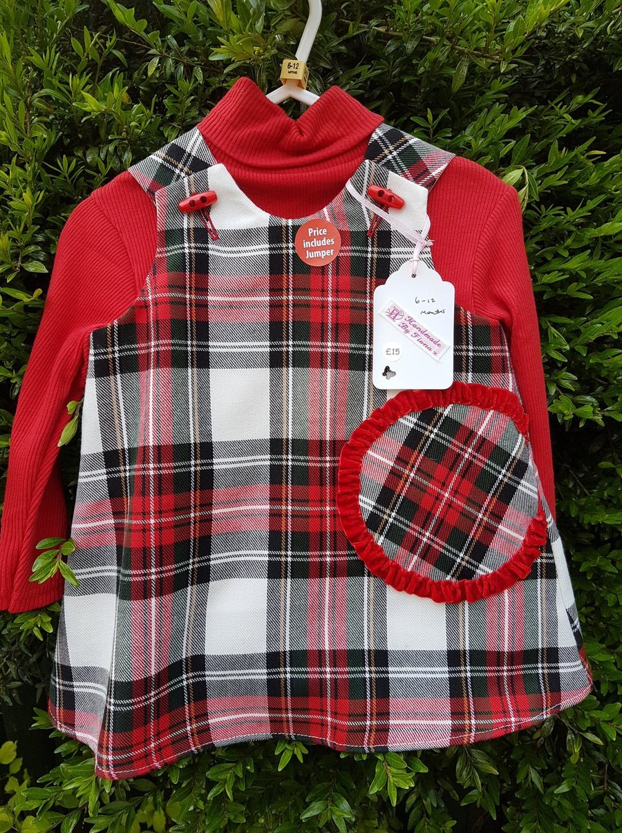 Age: 6-12m. Red check tartan lined pinafore dress. 