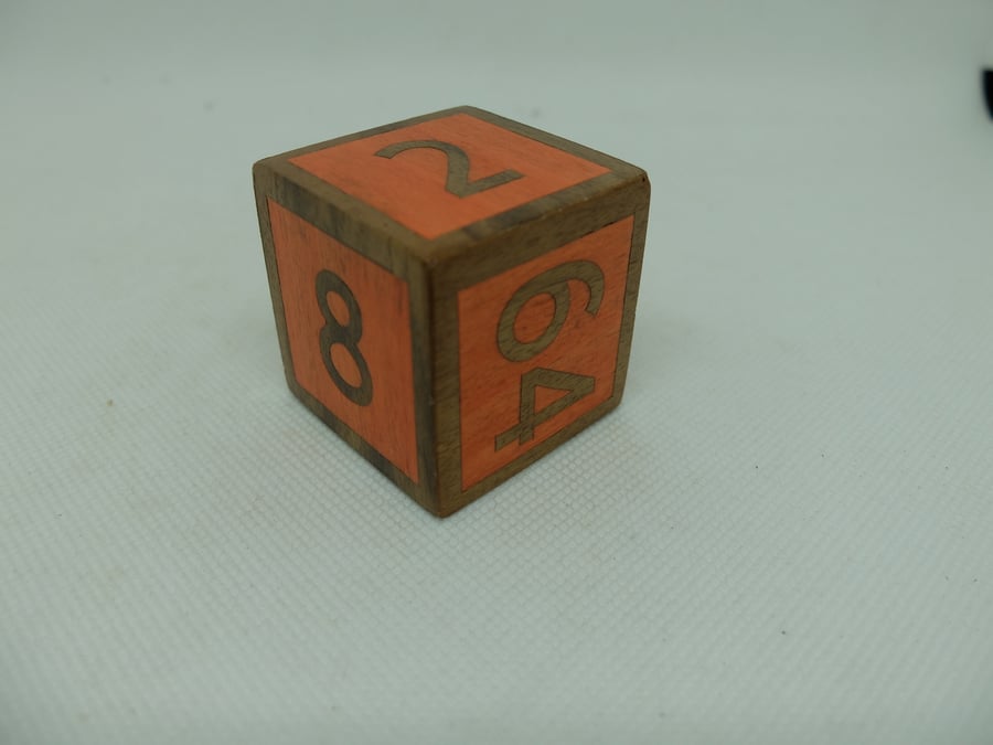 Orange veneered wooden doubling cube
