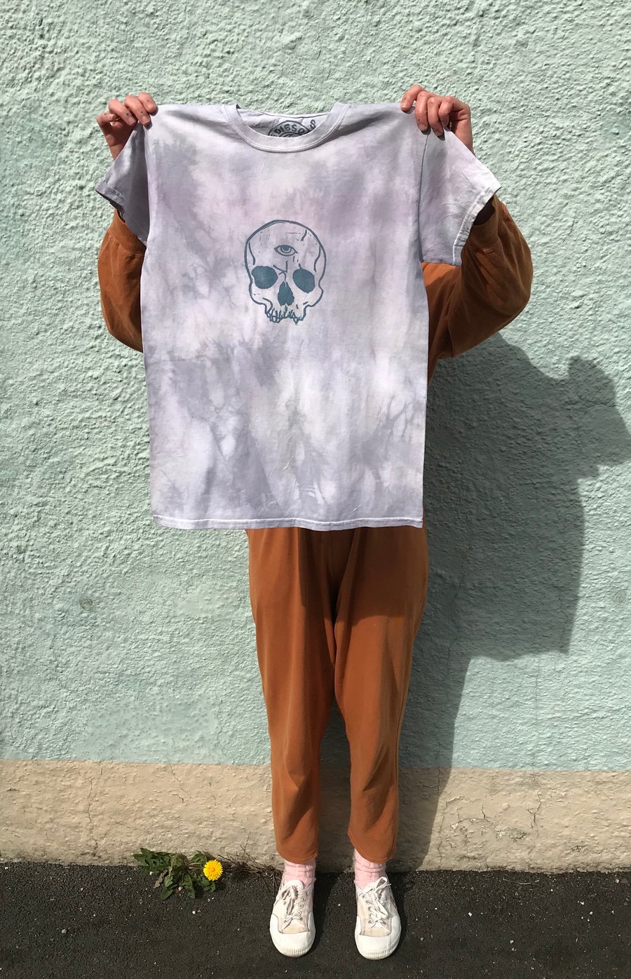 Natural plant dyed, blue tie-dye cotton t-shirt with linocut skull print.