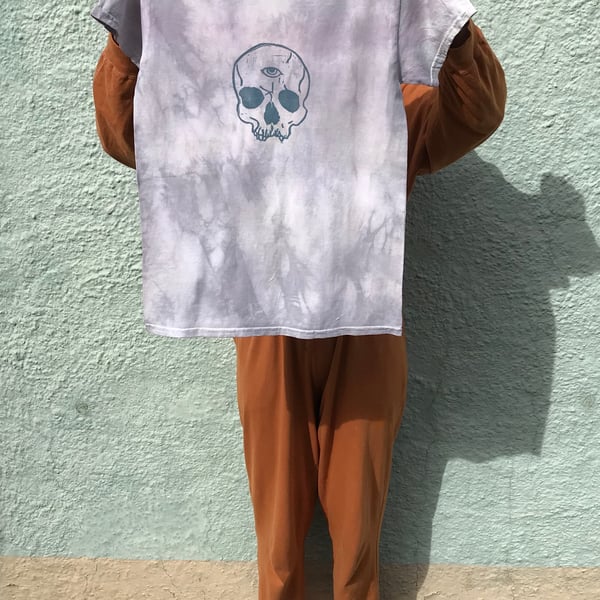 Natural plant dyed, blue tie-dye cotton t-shirt with linocut skull print.