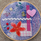 Hand sewn, slow stitch, embroidery hoop artwork, with ribbon for wall hanging