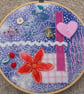 Hand sewn, slow stitch, embroidery hoop artwork, with ribbon for wall hanging