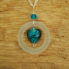 White glass pendant with turquoise striped heart