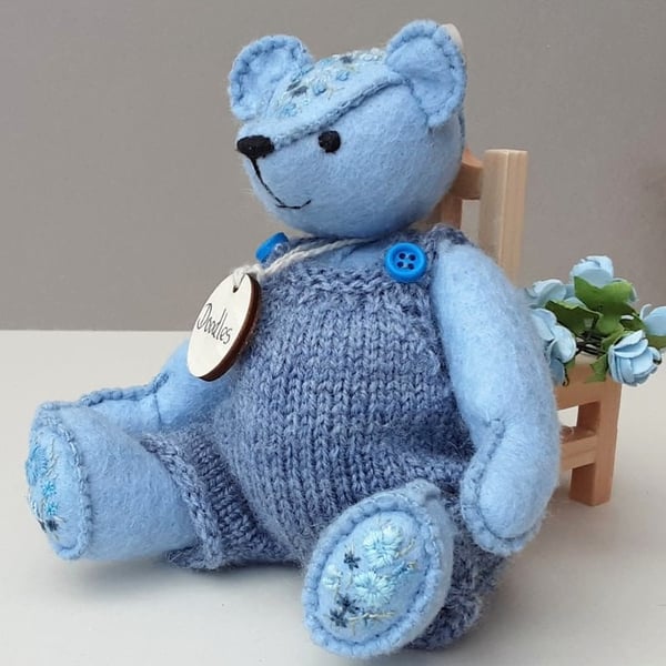 Dressed teddy bear in knitted dungarees, blue embroidered artist bear