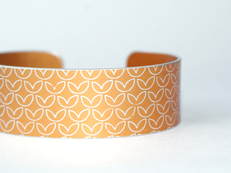 Leaf pattern aluminium cuff orangey yellow