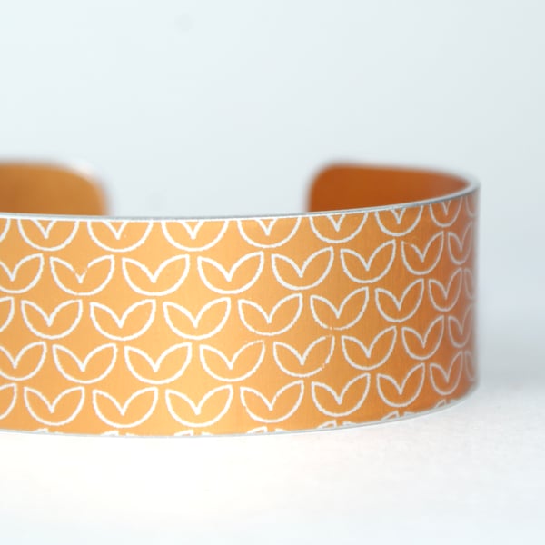 Leaf pattern aluminium cuff orangey yellow