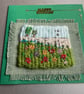  A woven birthday card with embroidered flowers 