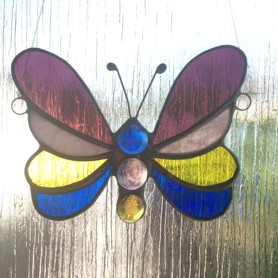 Banded stained glass butterfly suncatcher. (0560)