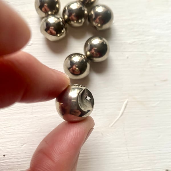 8 silver coloured sphere shaped vintage buttons with shank