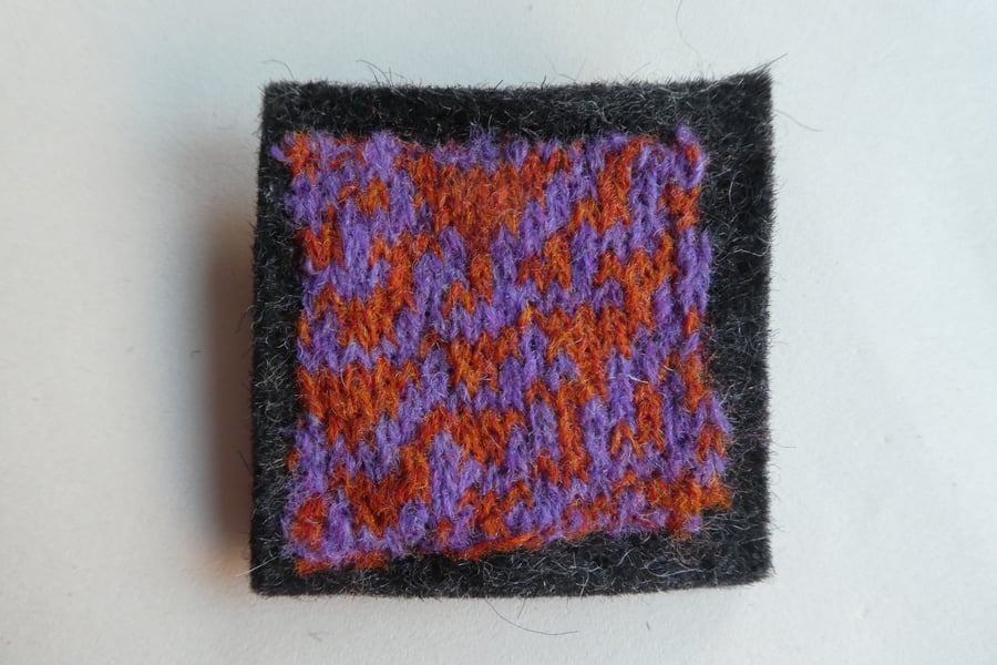 Rule 30 brooch - charcoal grey with orange and purple, square, needle felted.