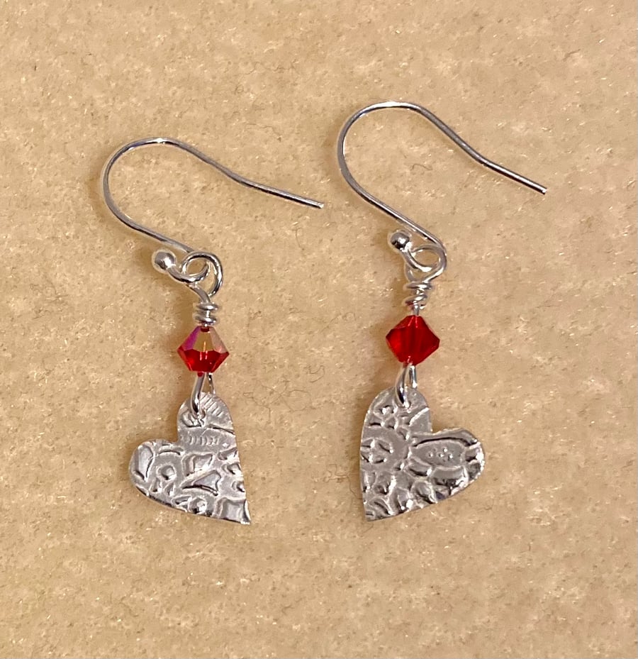 Silver, dangly heart earrings with red Swarovski crystals 