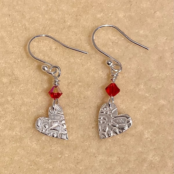 Silver, dangly heart earrings with red Swarovski crystals 