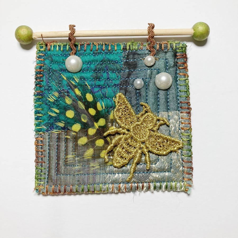 Miniature wallhanging, quilted patchwork with bee and feather