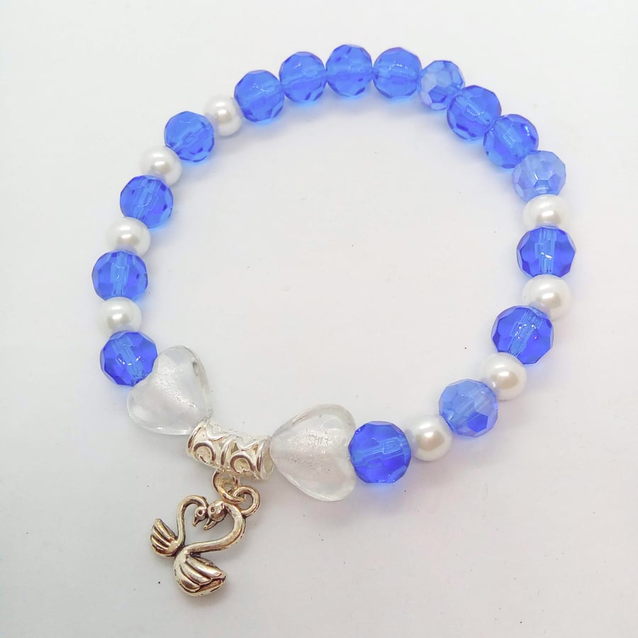 Stretch Bracelet with Blue and White Beads Heart Beads and a Silver Swan Charm